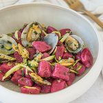 Beetroot gnocchi with clams and zucchini